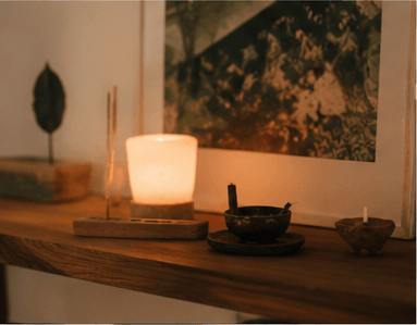 Candles and incense arranged for a small evening gathering.